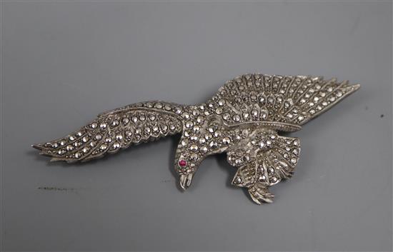 A white metal and marcasite set eagle brooch, with red paste eye, 80mm.